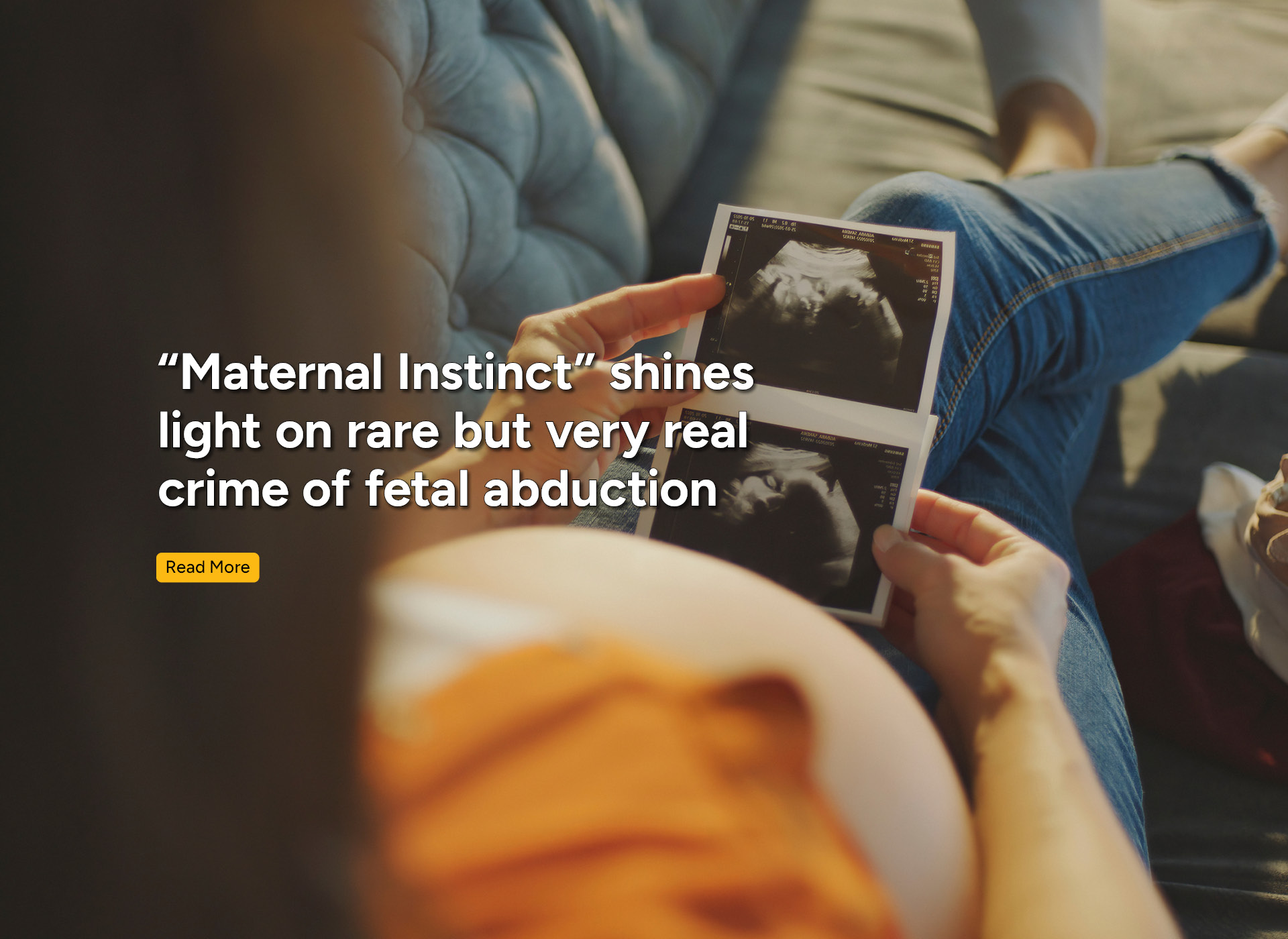 a pregnant woman looks at pictures of her sonogram